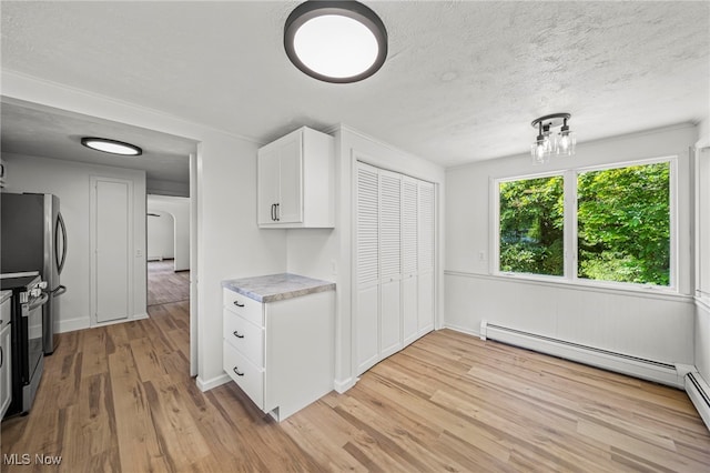 416 N Hambden St, Chardon, OH 44024 - kitchen with light wood-type flooring, stainless steel range with electric stovetop, light countertops, white cabinets, and baseboard heating