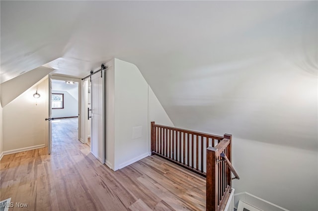 416 N Hambden St, Chardon, OH 44024 - additional living space with lofted ceiling, wood finished floors, and a barn door