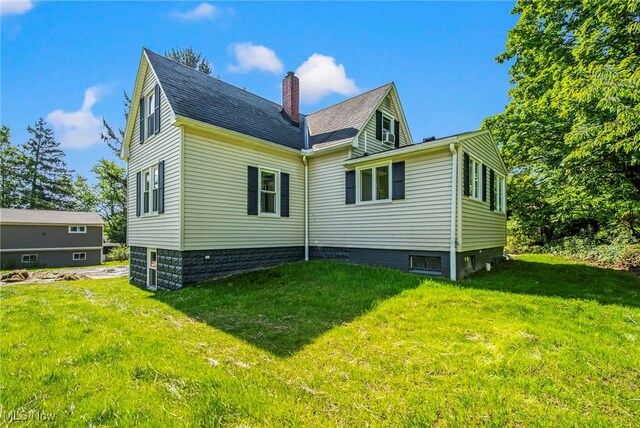 416 N Hambden St, Chardon, OH 44024 - back of house featuring a chimney, a yard, and roof with shingles