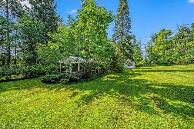 416 N Hambden St, Chardon, OH 44024 - view of green lawn with a wooded view