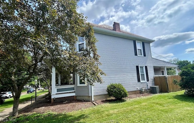 623 N 7th St, Marietta, OH 45750 - view of side of home featuring a chimney and a central air condition unit