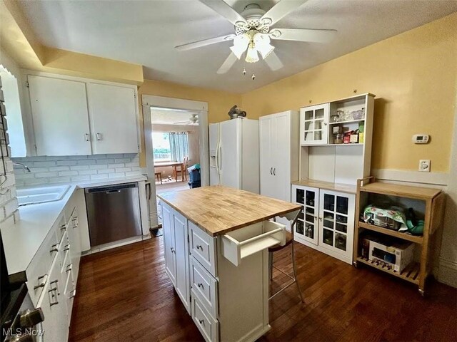 623 N 7th St, Marietta, OH 45750 - kitchen with dishwasher, white refrigerator with ice dispenser, a ceiling fan, dark wood finished floors, and butcher block countertops