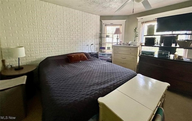 623 N 7th St, Marietta, OH 45750 - bedroom with brick wall, a textured ceiling, and ceiling fan