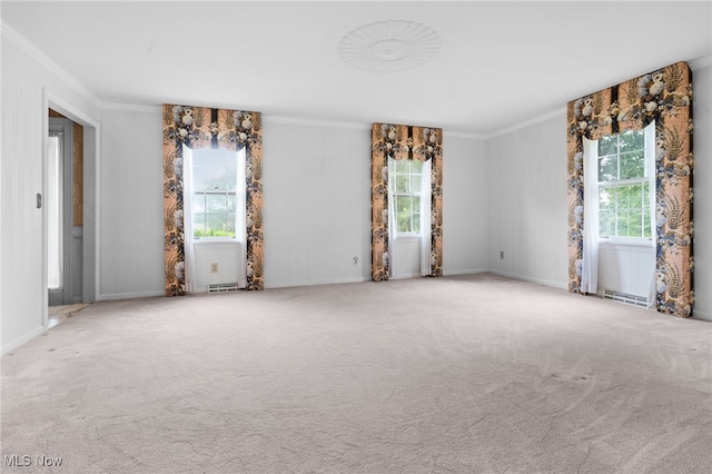 8640 Foxglove Ave NW, Clinton, OH 44216 - carpeted empty room with ornamental molding and healthy amount of natural light