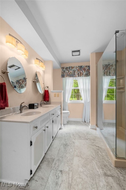 8640 Foxglove Ave NW, Clinton, OH 44216 - full bath featuring baseboards and double vanity