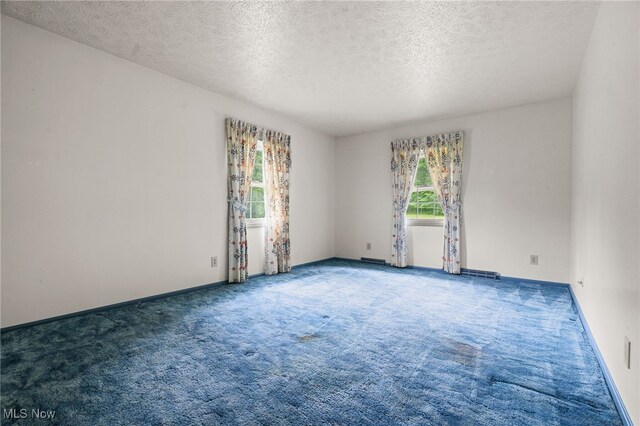 8640 Foxglove Ave NW, Clinton, OH 44216 - carpeted empty room with a textured ceiling and baseboards