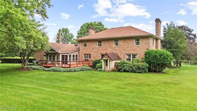 8640 Foxglove Ave NW, Clinton, OH 44216 - rear view of property with a chimney, a lawn, and a deck