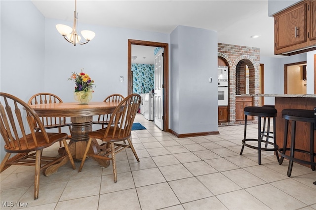 8640 Foxglove Ave NW, Clinton, OH 44216 - dining space with arched walkways and light tile patterned floors