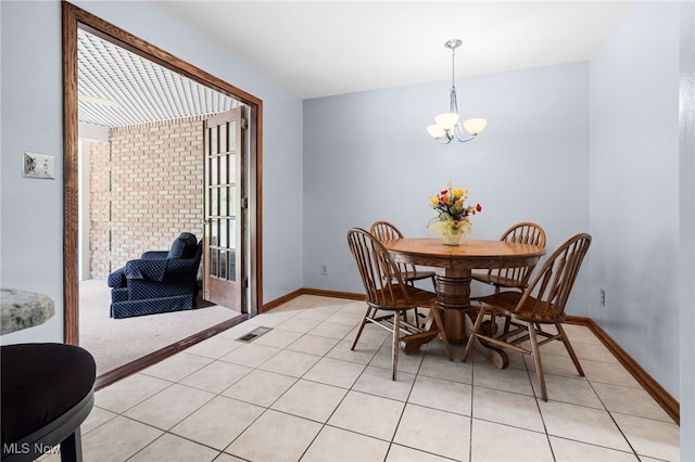 8640 Foxglove Ave NW, Clinton, OH 44216 - dining space featuring a chandelier and light tile patterned floors