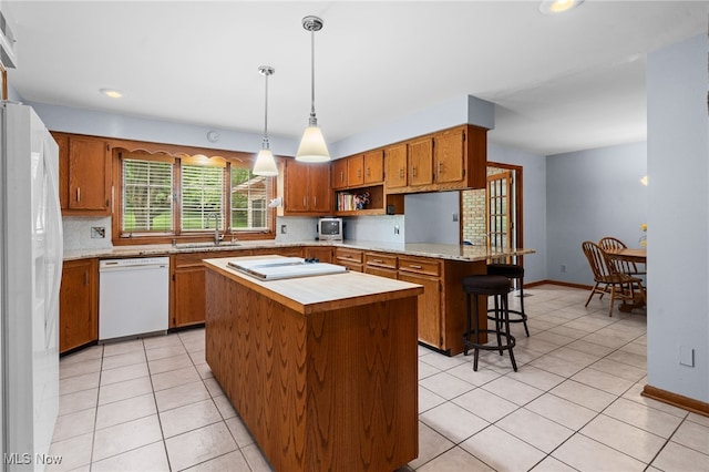 8640 Foxglove Ave NW, Clinton, OH 44216 - kitchen featuring white appliances, light countertops, light tile patterned floors, a peninsula, and recessed lighting