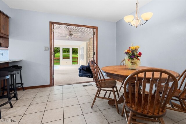 8640 Foxglove Ave NW, Clinton, OH 44216 - dining space featuring a chandelier and light tile patterned floors