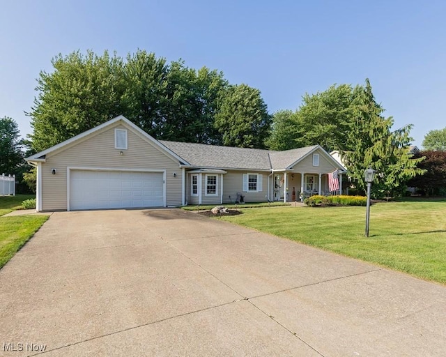 4053 Quail Ct, Ashtabula, OH 44004 - single story home featuring a front lawn, concrete driveway, a garage, and covered porch