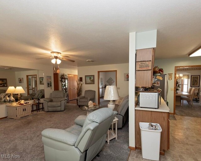 4053 Quail Ct, Ashtabula, OH 44004 - living room with light colored carpet, a ceiling fan, and a textured ceiling