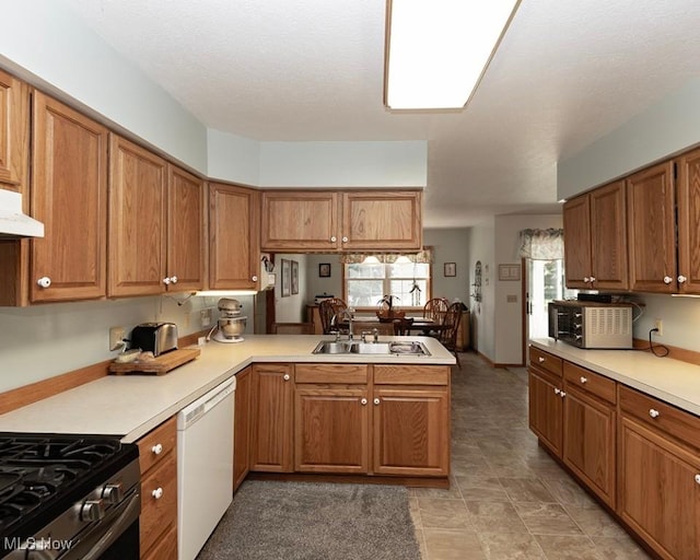 4053 Quail Ct, Ashtabula, OH 44004 - kitchen featuring dishwasher, a peninsula, brown cabinets, light countertops, and under cabinet range hood