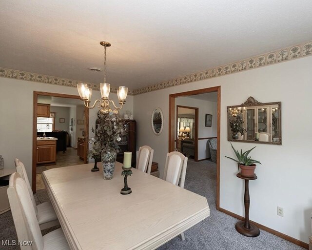 4053 Quail Ct, Ashtabula, OH 44004 - dining space with light colored carpet and a chandelier