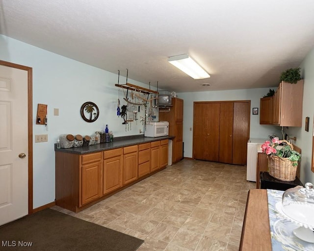 4053 Quail Ct, Ashtabula, OH 44004 - kitchen with white microwave and brown cabinets