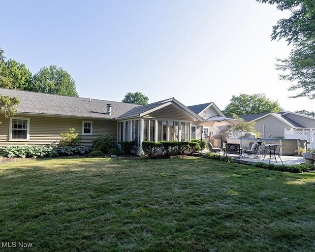 4053 Quail Ct, Ashtabula, OH 44004 - view of front facade with a patio, a front lawn, and a sunroom