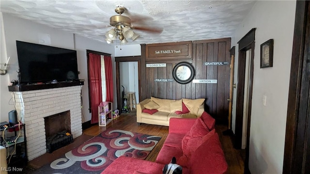 2310 7th St SW, Canton, OH 44706 - living room featuring ceiling fan, a fireplace, and wood finished floors