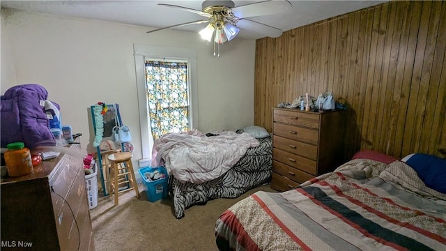 2310 7th St SW, Canton, OH 44706 - carpeted bedroom with wooden walls and ceiling fan