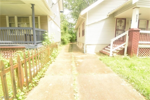 853 E 144th St, Cleveland, OH 44110 - view of property exterior with a porch and concrete driveway