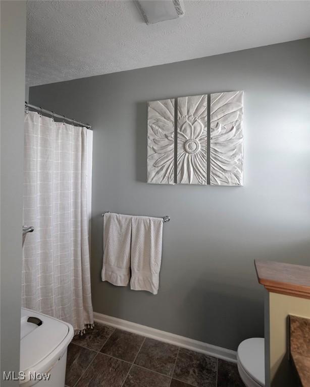 114 Westminster Way, Elyria, OH 44035 - full bathroom featuring vanity, a shower with shower curtain, and a textured ceiling