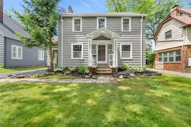 3294 Avalon Rd, Shaker Heights, OH 44120 - colonial-style house with a front yard, entry steps, and a chimney