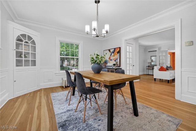 3294 Avalon Rd, Shaker Heights, OH 44120 - dining room featuring light wood-style flooring, a chandelier, ornamental molding, and an AC wall unit