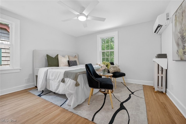 3294 Avalon Rd, Shaker Heights, OH 44120 - bedroom featuring a wall mounted air conditioner, light wood-type flooring, and a ceiling fan