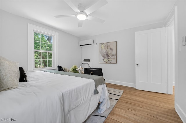 3294 Avalon Rd, Shaker Heights, OH 44120 - bedroom with an AC wall unit, wood finished floors, and a ceiling fan