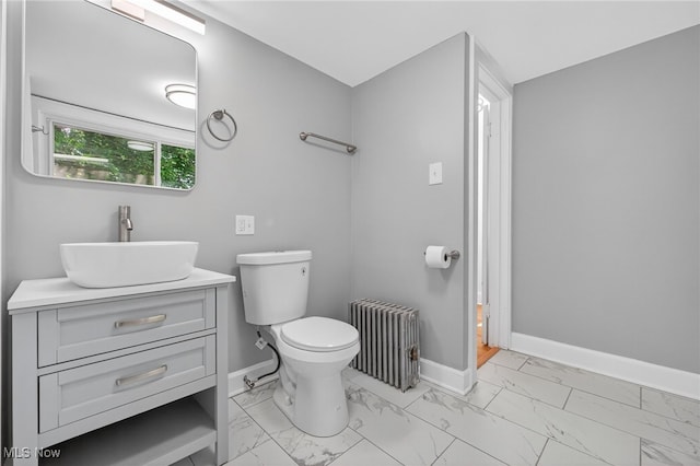 3294 Avalon Rd, Shaker Heights, OH 44120 - bathroom with radiator heating unit, marble look tile flooring, and vanity