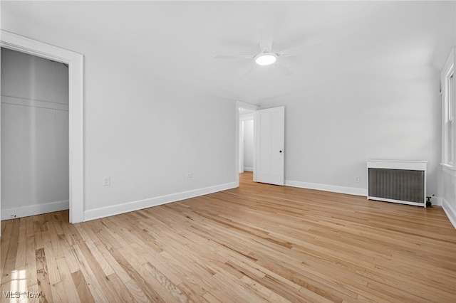 3294 Avalon Rd, Shaker Heights, OH 44120 - unfurnished bedroom with radiator heating unit, light wood-style floors, and ceiling fan