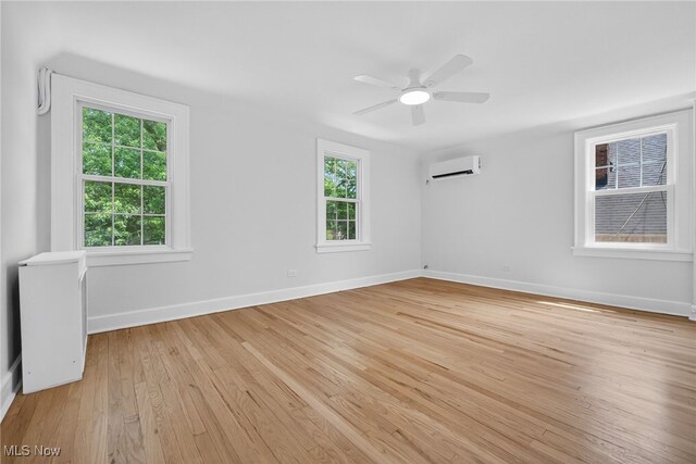 3294 Avalon Rd, Shaker Heights, OH 44120 - unfurnished room featuring a wall mounted AC, light wood-type flooring, plenty of natural light, and a ceiling fan