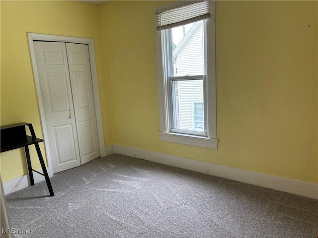 629 E 5th St, Salem, OH 44460 - unfurnished bedroom with carpet, multiple windows, and a closet