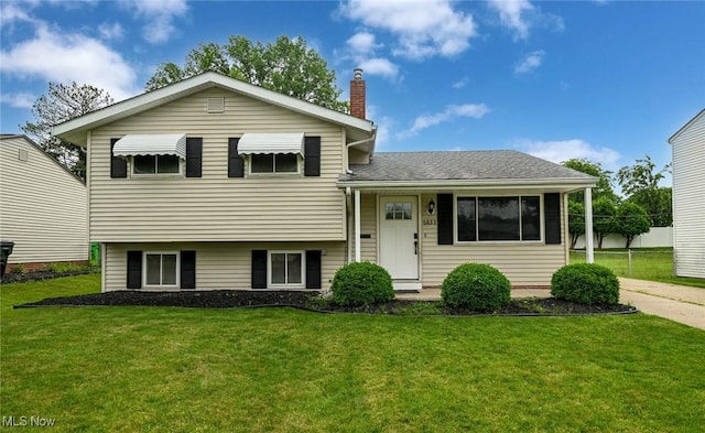 6633 Tamarind Dr, Bedford Heights, OH 44146 - split level home featuring a chimney, a front lawn, and roof with shingles