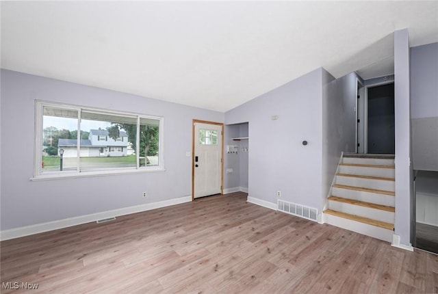 6633 Tamarind Dr, Bedford Heights, OH 44146 - foyer entrance featuring wood finished floors, stairs, and vaulted ceiling