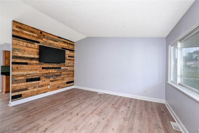 6633 Tamarind Dr, Bedford Heights, OH 44146 - unfurnished living room with wood finished floors and lofted ceiling