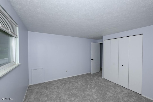 6633 Tamarind Dr, Bedford Heights, OH 44146 - unfurnished bedroom with carpet, a textured ceiling, and a closet