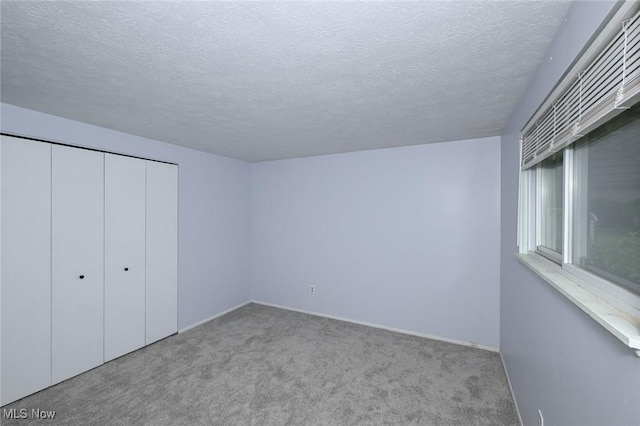 6633 Tamarind Dr, Bedford Heights, OH 44146 - unfurnished bedroom with carpet, a textured ceiling, and a closet