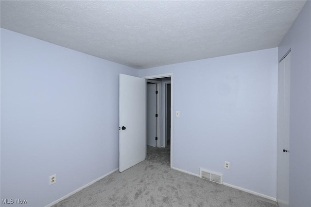 6633 Tamarind Dr, Bedford Heights, OH 44146 - unfurnished room featuring light colored carpet and a textured ceiling