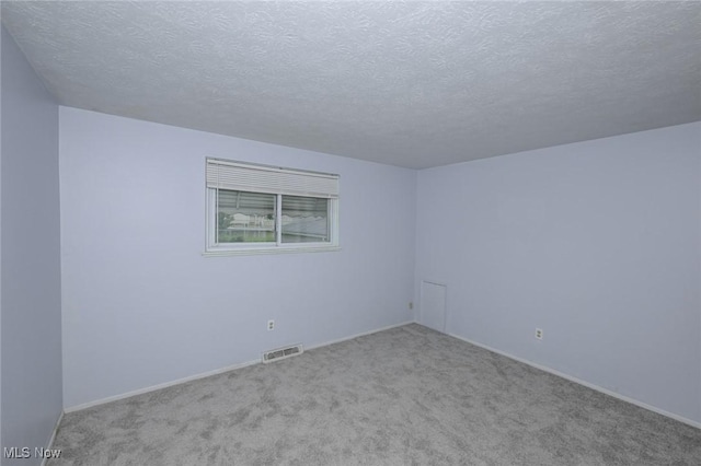 6633 Tamarind Dr, Bedford Heights, OH 44146 - carpeted spare room featuring a textured ceiling and baseboards