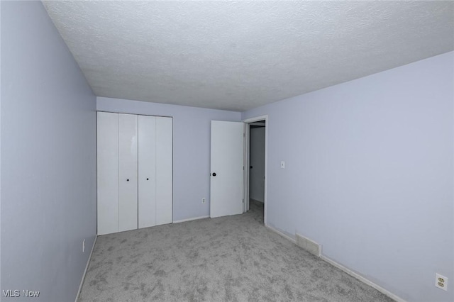 6633 Tamarind Dr, Bedford Heights, OH 44146 - unfurnished bedroom with carpet flooring, a textured ceiling, and a closet