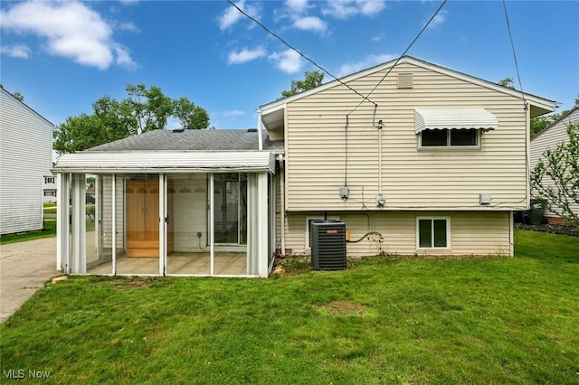 6633 Tamarind Dr, Bedford Heights, OH 44146 - rear view of house featuring a sunroom and a lawn