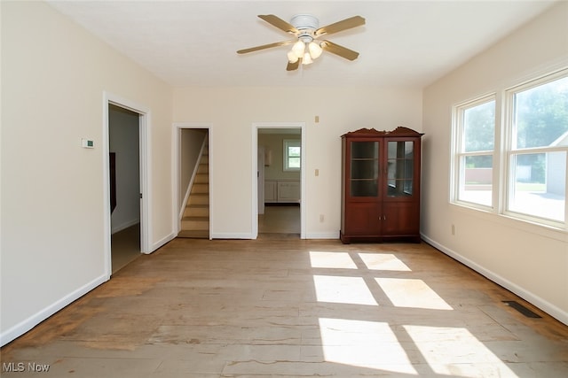 874 Cleveland Ave, Amherst, OH 44001 - unfurnished room with stairs, ceiling fan, and light wood-type flooring