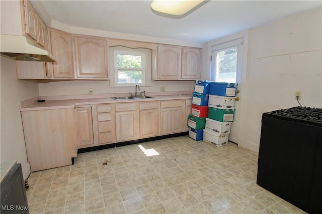 874 Cleveland Ave, Amherst, OH 44001 - kitchen featuring light brown cabinets, under cabinet range hood, and healthy amount of natural light