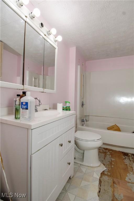 874 Cleveland Ave, Amherst, OH 44001 - bathroom featuring vanity, bathtub / shower combination, a textured ceiling, and tile patterned floors