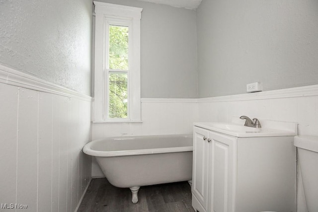 8023 Kosciuszko Ave, Cleveland, OH 44103 - bathroom with wainscoting, wood finished floors, a soaking tub, and healthy amount of natural light
