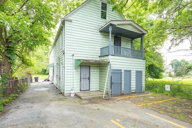 8023 Kosciuszko Ave, Cleveland, OH 44103 - rear view of property with a balcony and uncovered parking