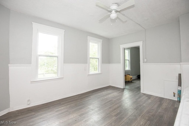 8023 Kosciuszko Ave, Cleveland, OH 44103 - spare room featuring wood finished floors, a ceiling fan, and wainscoting