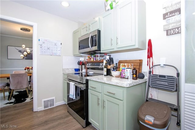 1058 Greenwood Ave, Akron, OH 44320 - kitchen featuring appliances with stainless steel finishes, light countertops, wood finished floors, and recessed lighting