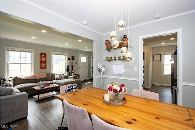 1058 Greenwood Ave, Akron, OH 44320 - dining space featuring healthy amount of natural light, ornamental molding, dark wood finished floors, and recessed lighting